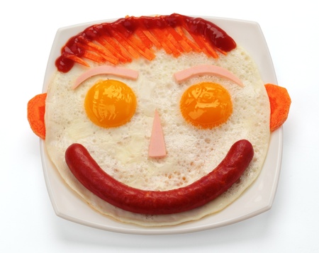 Sausage and scrambled eggs on a white plateの写真素材