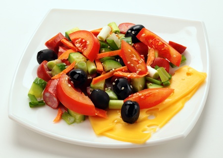 salad with olives on a white plateの写真素材