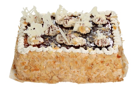 Delicious cake with chocolate and nuts, garnished with cream.の写真素材
