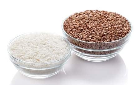 rice and buckwheat in a glass bowl isolated on white backgroundの写真素材