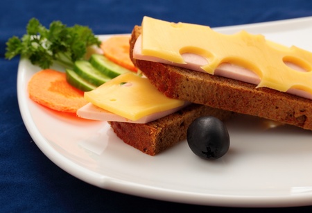 sandwich with ham and cheese on a blue backgroundの写真素材
