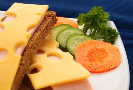 sandwich with ham and cheese on a blue backgroundの写真素材