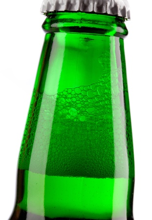 Beer bottle with drops isolated on white の写真素材