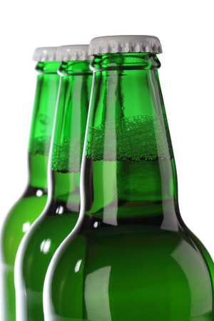 Beer bottle with drops isolated on white の写真素材