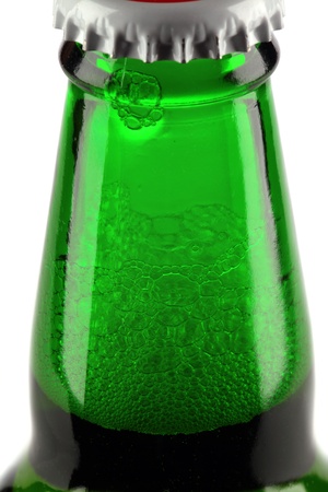 Beer bottle with drops isolated on white の写真素材