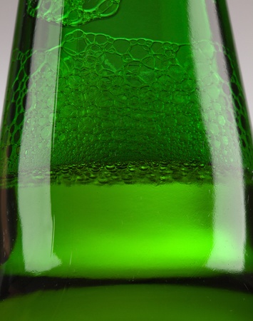 Beer bottle with drops on white の写真素材