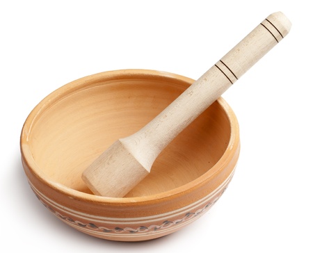 empty clay bowl with a wooden spoon isolated on white background の写真素材