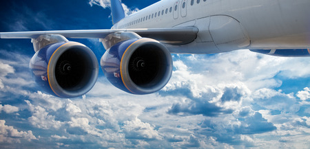 Big airliner in the blue sky with clouds.の写真素材