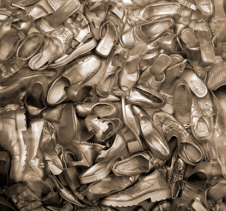 Lots of old gold color shoes. の写真素材