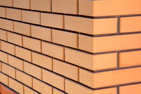 Yellow Facing Brick Wall with a smooth surface in the cornerの写真素材