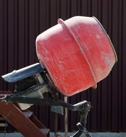 Orange Cement Mixer at a construction siteの写真素材