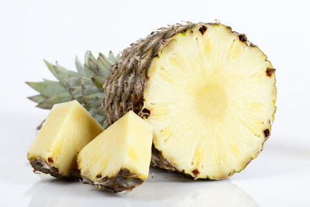 Pineapple with slices on white backgroundの写真素材