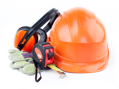Orange plastic construction Helmet, roulette, gloves, headphones on a white backgroundの写真素材