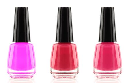 Bottle red and pink nail polishes isolated on white backgroundの写真素材