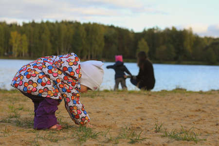 Mother with two children walking on the autumn beachの写真素材