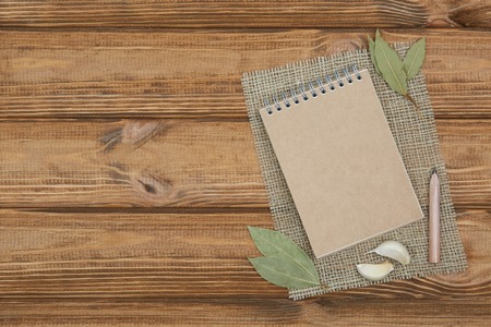 Blank notepad for copy space and herbs on wooden tableの写真素材