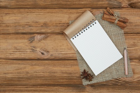 Blank notepad for copy space and herbs on wooden tableの写真素材