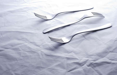 Three forks on crumpled backgroundの写真素材
