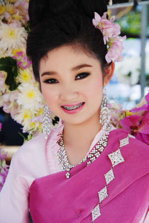 CHIANG MAI - FEB 6: Traditionally dressed girl with fowers in her hair on Chiang Mai 34th Flower Festival on February 6th, 2010. Chiang Mai, Thailand のeditorial素材