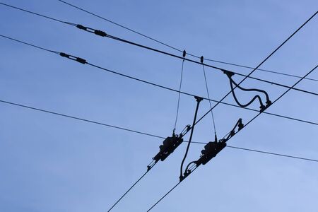 black wires intersect  in the blue skyの写真素材