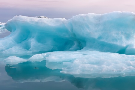 blue glacial ice in crystal clear waterの写真素材