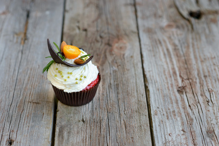 Tasty cake with pieces of fruits and strawberry on a tableの写真素材