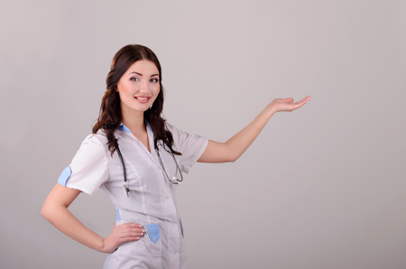 The smiling female doctor in a white dressing gownの写真素材