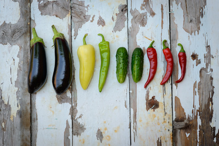 The crop of vegetables which is spread out on a wooden backgroundの写真素材