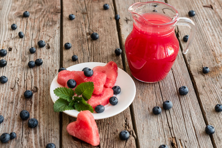 Watermelon juice on a wooden table. It can be used as a backgroundの写真素材