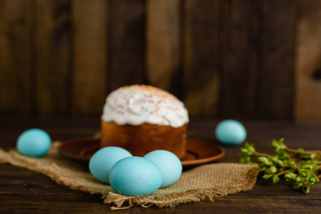 Easter cake and colorful eggs on a wooden table. It can be used as a backgroundの写真素材