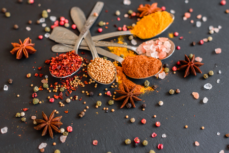 Various spices on wooden spoons. Food ingredientsの写真素材