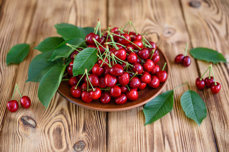 Tasty juicy sweet cherry on a wooden background.の写真素材