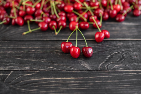 Tasty juicy sweet cherry on a wooden background.