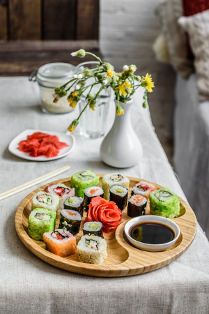 Fresh and tasty sushi on dark background. It can be used as a backgroundの写真素材