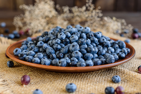 Fresh berries of blueberry on a plate. It can be used as a backgroundの写真素材