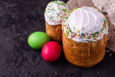 Easter, cake, eggs, holiday. Easter cake and colorful eggs on a dark background. It can be used as a backgroundの写真素材