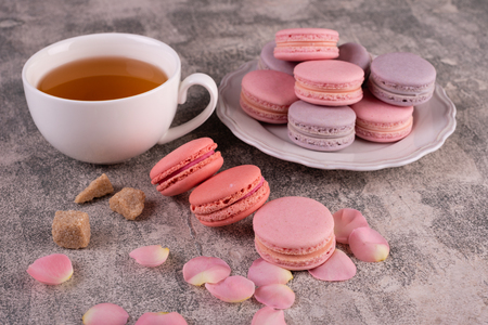 Wedding, St. Valentine's Day, birthday, preparation, holiday. Beautiful pink tasty macaroons on a concrete backgroundの写真素材