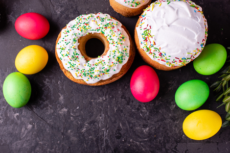 Easter, cake, eggs, holiday. Easter cake and colorful eggs on a dark background. It can be used as a...