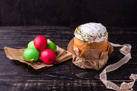 Easter, cake, eggs, holiday. Easter cake and colorful eggs on a dark background. It can be used as a...