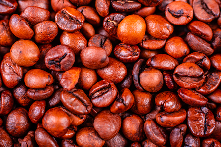 Seeds of fragrant coffee on a dark concrete background. It can be used as a backgroundの写真素材