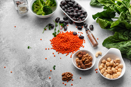 Healthy vegan food background with copy space. Nuts, beans, greens and seedsの写真素材