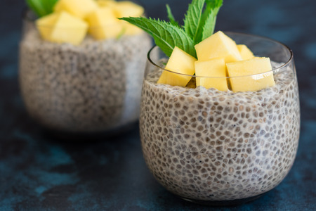Beautiful and tasty dessert with mango and seeds of a chia. A fresh pudding for breakfastの写真素材
