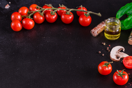 Ingredients for preparation of tasty Italian pizza. Cherry tomato, spices, basil, chili pepperの写真素材