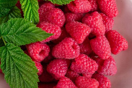 Sweet fresh organic raspberries background close-up