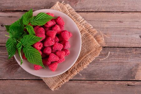 Sweet fresh organic raspberries background close-up
