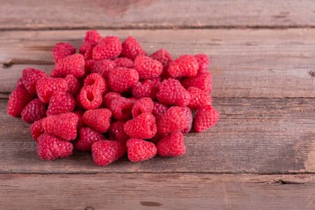 Sweet fresh organic raspberries background close-up