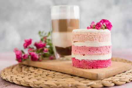 Beautiful pink cream and berries cake on a light concrete background. Birthday celebrationの写真素材