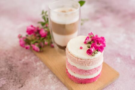 Beautiful pink cream and berries cake on a light concrete background. Birthday celebrationの写真素材