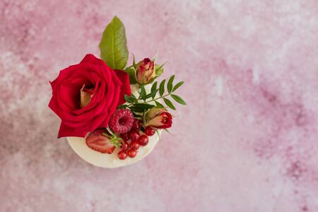 Beautiful pink cream and berries cake on a light concrete background. Birthday celebrationの写真素材