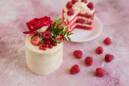 Beautiful pink cream and berries cake on a light concrete background. Birthday celebrationの写真素材